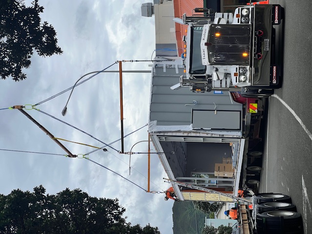 A truck moves a section of the new Moerā building